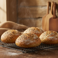 Sourdough seed buns on a wire cooling rack