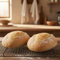 Traditional small white tin loaves on a wire cooling rack