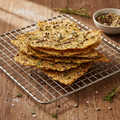Crispy sourdough crackers with seeds on a wire rack